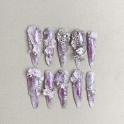 Luxury long press-on nails with lavender tones and Swarovski crystal embellishments for a glamorous finish