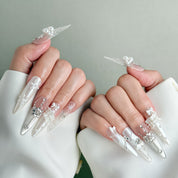 Model wearing Just the Two of Us nails featuring shimmering metallic accents and delicate flower details