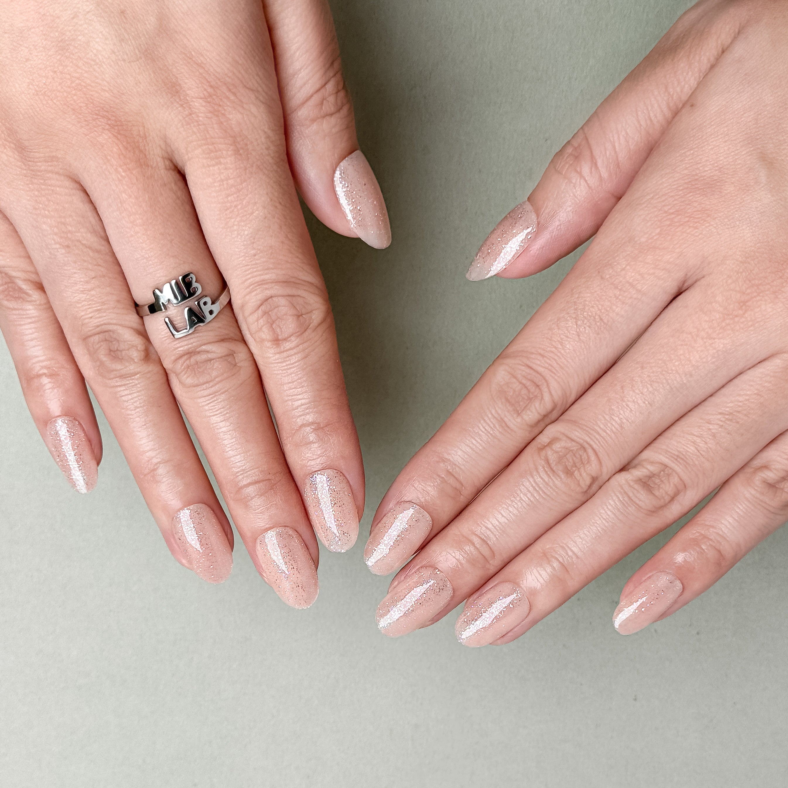 Close-up of nude beige pearlescent press-on nails by MIBLAB, luxury handcrafted design from the You and Me collection Geneva.