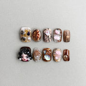 Velvet Parade : faux ongles réutilisables motifs artistiques, fleurs et marbré, tons bruns et nude, détails dorés, press on nails premium.