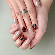 Gros plan Miss You More : faux ongles réutilisables nude laqué, accent écaille ambre, finition glossy, Suisse.