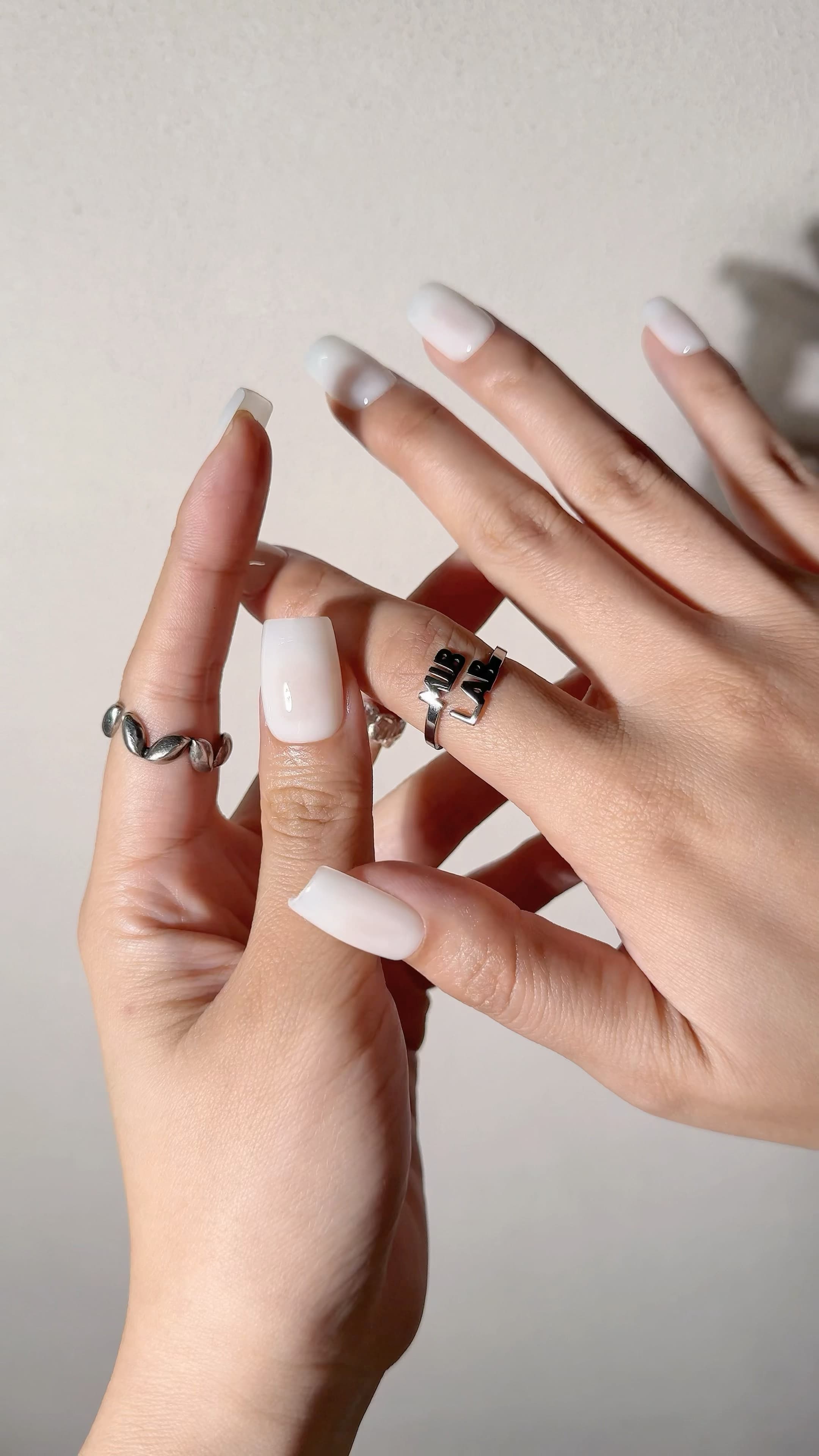 Manucure Milk+ portée : press on nails blanc laiteux glossy, look naturel et épuré, ongles sans gel, Genève.