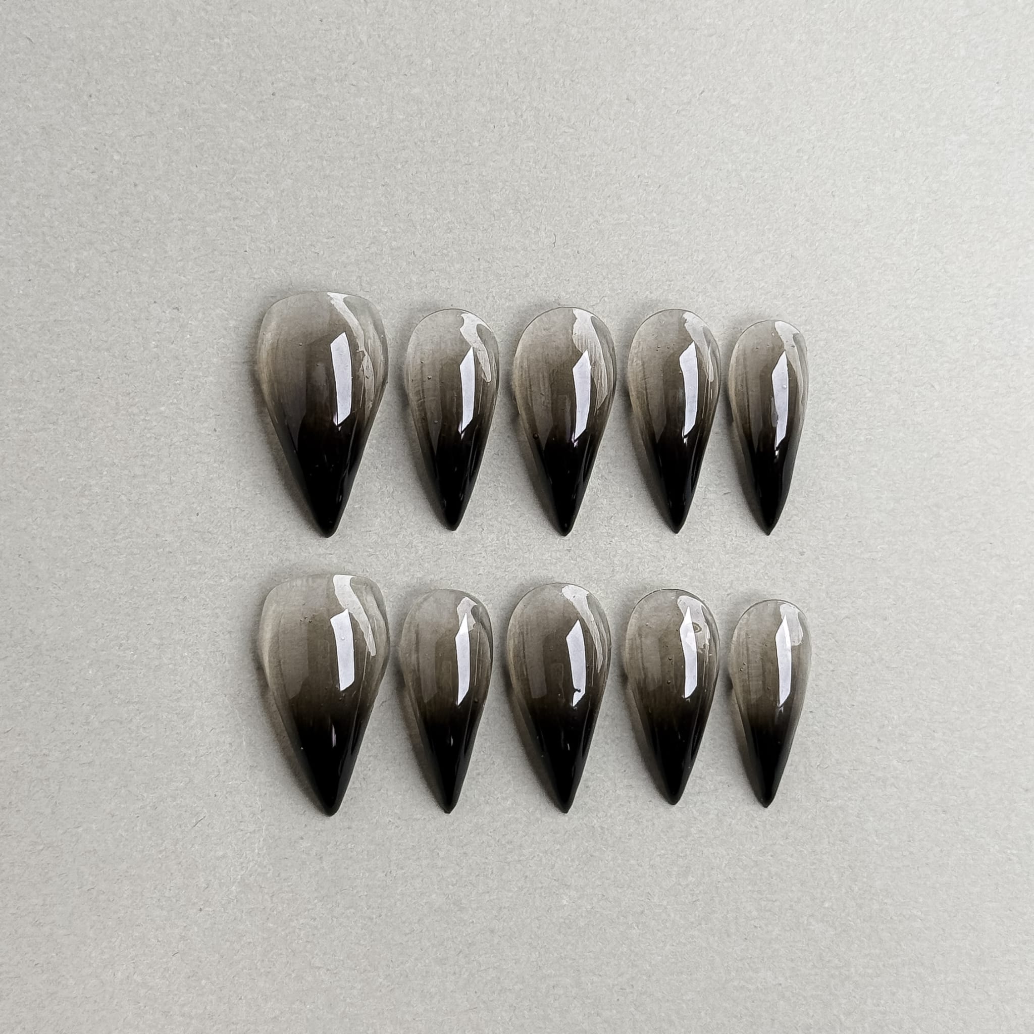 Grip : faux ongles réutilisables dégradé nude vers noir, finition glossy, forme longue stiletto, press on nails premium.